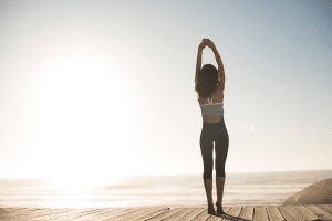 woman stretching near the beach for wellness